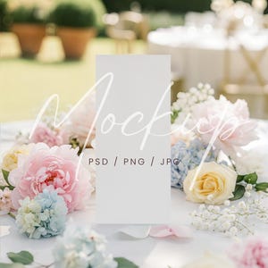 May include: A blank white rectangular sign, surrounded by pastel-colored flowers, including pink peonies, blue hydrangeas, and yellow roses. The sign has the word "Mockups" in a script font and the text "PSD / PNG / JPG".