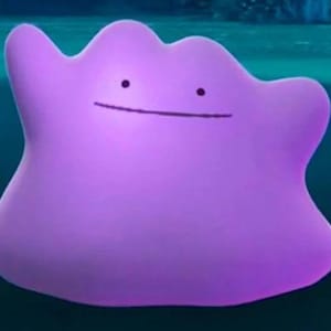 May include: A purple, amorphous Pokemon character with a wide, friendly smile. The character is floating in a blue, watery background.