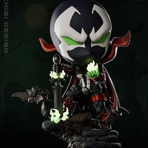 May include: A chibi-style Spawn figure, featuring a black and white mask with green eyes, a red cape, and holding a glowing green sword. The figure stands on a stone base with bats and glowing green flames. The figure is labeled as 1-6 scale.