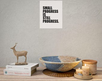 May include: A black and white typography print with the text "SMALL PROGRESS IS STILL PROGRESS."