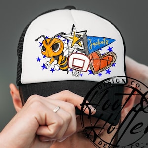 May include: A black and white trucker hat with a cartoon bee, basketball, and star design. The design includes the word "Jackets" on a blue pennant, a basketball-shaped heart, and blue star accents.