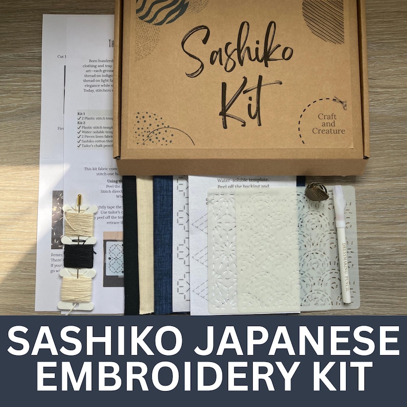 May include: A Sashiko Japanese embroidery kit in a brown box. The kit includes fabric, thread, a stencil, and a marking pen. The box has the words "Sashiko Kit" and "Craft and Creature" printed on it. The words "Sashiko Japanese Embroidery Kit" are printed at the bottom.