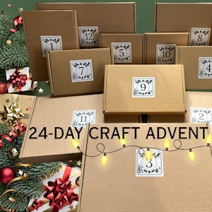 May include: A collection of brown cardboard boxes of varying sizes, each labeled with a white square sticker featuring a number and craft-themed icons. The text 24-DAY CRAFT ADVENT is printed in black across the center, accompanied by a string of yellow lights.