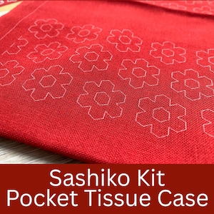 May include: A red pocket tissue case with a white floral pattern. The fabric has a textured appearance. The text "Sashiko Kit Pocket Tissue Case" is displayed at the bottom of the image.