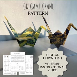 May include: Two origami cranes made from patterned paper, one yellow and green, the other navy and gold, stand on a surface. The text "ORIGAMI CRANE PATTERN" is above them. Below, a digital download is offered with a YouTube instructional video.