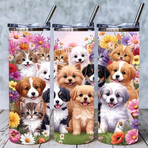 May include: Stainless steel tumbler with a vibrant design of cartoon puppies and kittens amidst flowers. The tumbler has a silver lid and a straw. The design includes various breeds of dogs and cats.