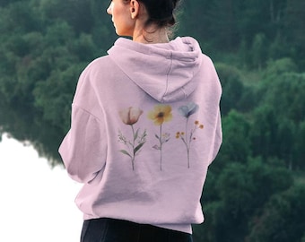 May include: A pink hoodie with a floral design on the back. The flowers are in shades of yellow, blue, and pink.
