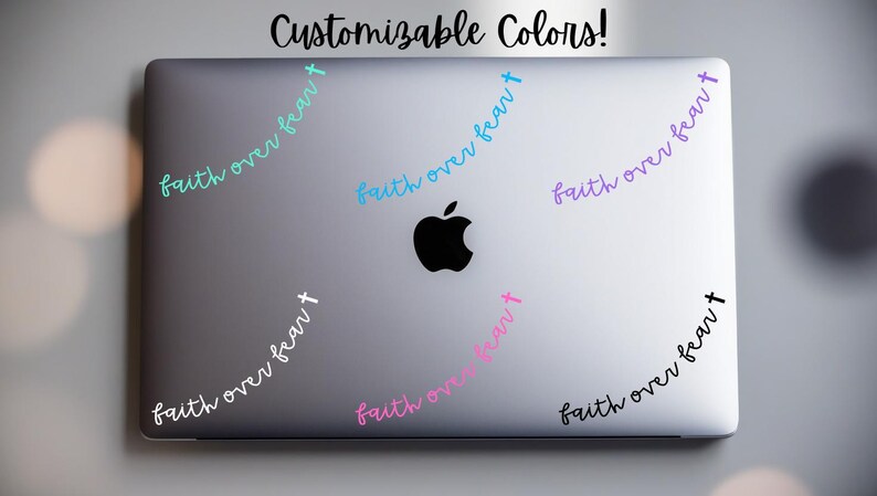 May include: A laptop with the Apple logo has several "faith over fear" decals in various colors. The text "Customizable Colors!" is at the top. The decals are in teal, blue, purple, pink, white, and black.