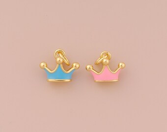 May include: Two gold-colored crown charms, one with blue enamel and one with pink enamel.