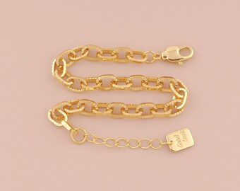 May include: A gold chain bracelet with a textured finish and a small tag that reads "Love, Grace".