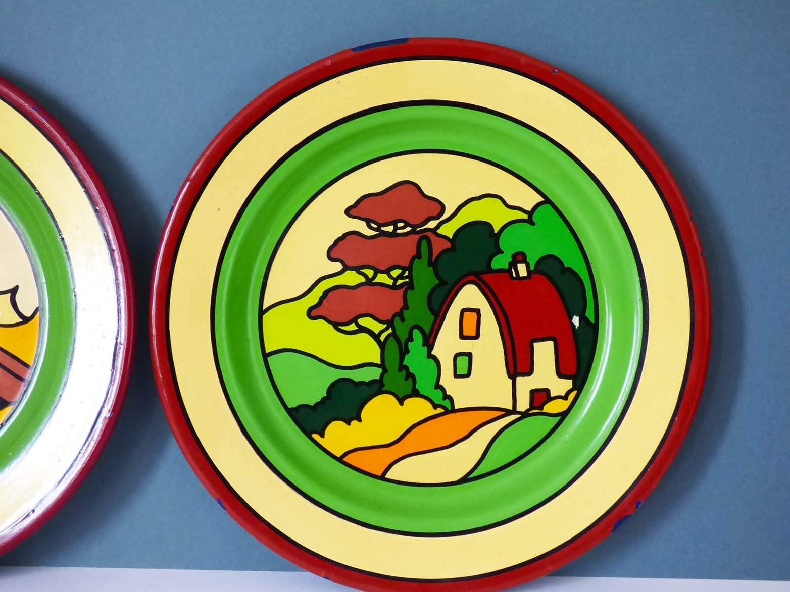 Vintage enamel plates in the style of Clarice Cliff