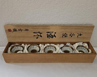 Set Of Five Japanese Kutani Ware Sake Cups In A Traditional Wooden Storage Case.