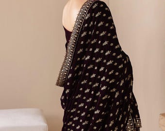 May include: A deep purple velvet shawl draped over the shoulder, featuring intricate gold embroidery in a repeating floral pattern and a wide, heavily embellished border with metallic thread work and small reflective accents along the edge.