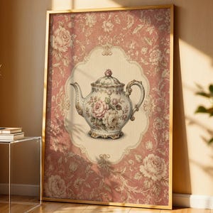 May include: A framed wall art print featuring a central illustration of a porcelain teapot decorated with pink and white roses, set against a cream-coloured scalloped background, all surrounded by a dusty rose floral damask patterned border.