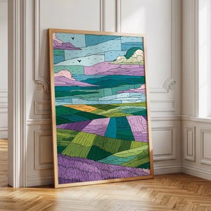 May include: A rectangular framed wall art print featuring a stylized landscape with segmented fields in shades of green, purple, and yellow. The sky is composed of blue and pink horizontal sections with two small black birds flying near the clouds.