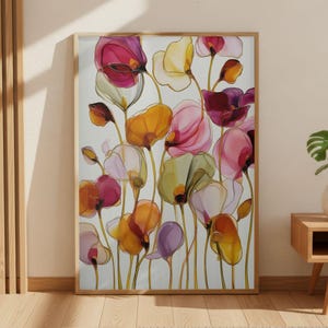 May include: A framed floral art print featuring colorful, translucent flowers in shades of pink, orange, yellow, and purple. The artwork is set against a white background, with a wooden frame. The print is displayed in a well-lit room.