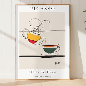 May include: A framed art print featuring a Picasso-style illustration of a teapot pouring into a teacup. The artwork uses a minimalist line style with yellow, red, green, and orange accents. The print includes the text "PICASSO" and "Uffizi Gallery Collection de Dessins".