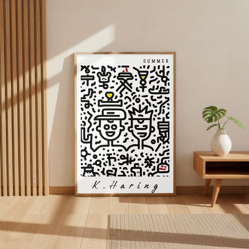 May include: A framed art print featuring a black and white illustration with the word "SUMMER" at the top. The artwork includes two cartoon figures and various abstract shapes. The artist's signature, "K. Haring," is at the bottom.