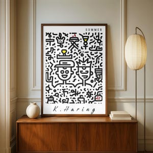May include: A framed art print featuring a black and white illustration with the word "SUMMER" at the top. The artwork includes two stylized figures and various abstract shapes. The artist's signature, "K. Haring," is at the bottom.
