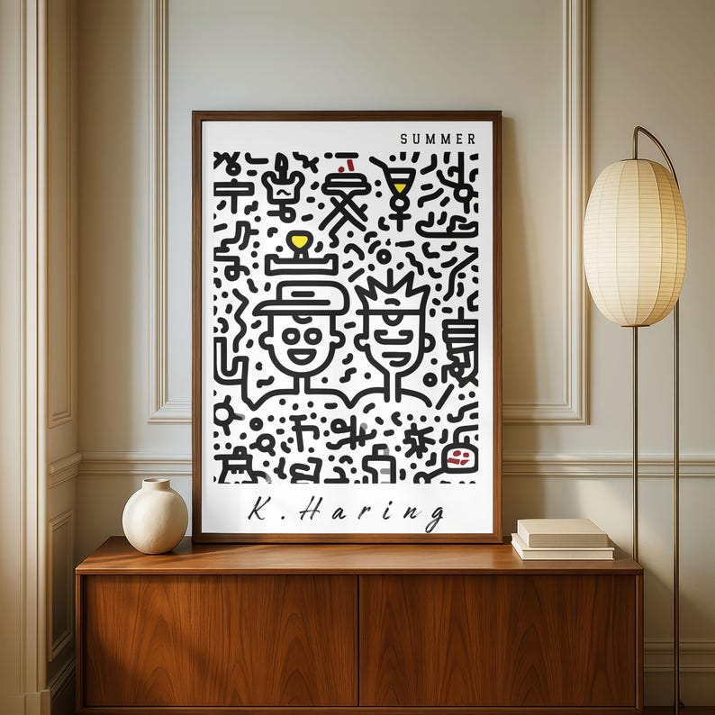 May include: A framed art print featuring a black and white illustration with the word "SUMMER" at the top. The artwork includes two stylized figures and various abstract shapes. The artist's signature, "K. Haring," is at the bottom.