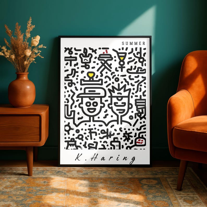 May include: Black framed art print featuring a Keith Haring design with the word "SUMMER" at the top. The artwork includes two cartoon figures and various abstract shapes in black on a white background. The artist's signature, "K. Haring," is at the bottom.