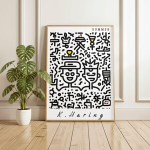 May include: A framed art print featuring a black and white Keith Haring-style illustration with the word "SUMMER" at the top. The artwork includes two stylized figures and various abstract shapes. The artist's signature, "K. Haring," is at the bottom.