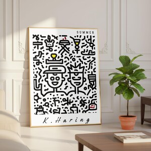 May include: A framed art print featuring a black and white Keith Haring-style illustration with the word "SUMMER" at the top. The artwork includes two stylized figures and various symbols. The artist's signature, "K. Haring," is at the bottom.