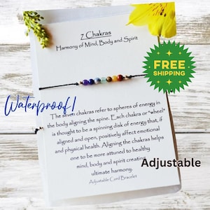 May include: A black string bracelet with seven colorful beads representing the seven chakras. The card reads "7 Chakras Harmony of Mind, Body and Spirit" and "Waterproof! Adjustable".