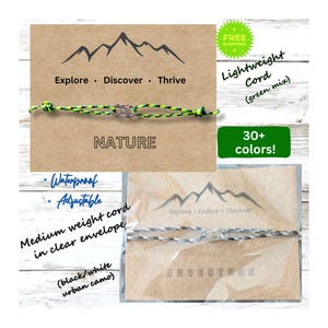May include: Two adjustable bracelets with mountain range designs and the words "NATURE" and "ADVENTURE". The bracelets are made of a lightweight cord in green and black/white color combinations. The text "Explore. Discover. Thrive" and "Explore. Endure. Discover" are also included.