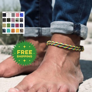 May include: A multi-colored braided cord anklet worn around the ankle. A color chart labeled Heavy Cord Colors 2.4mm displays various cord options including black, white, red, blue, green, and orange patterns in a grid format.