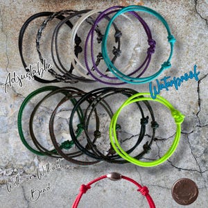 May include: Assortment of adjustable, waterproof bracelets in various colors, including black, white, purple, teal, green, and neon green. Some bracelets have a knot closure, while others have a bead. The text "Adjustable" and "Waterproof" are visible.
