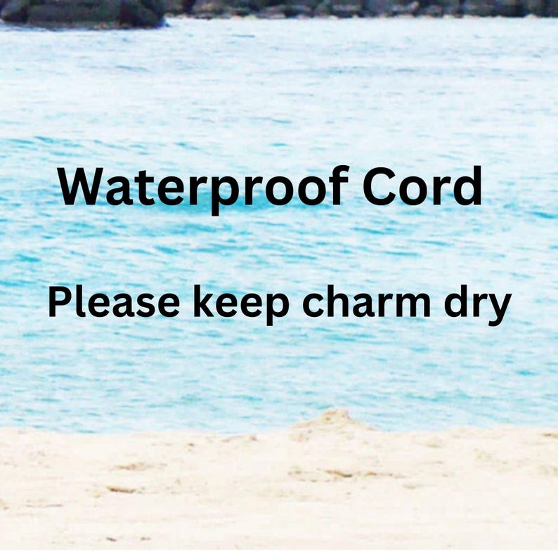 May include: Image of a serene beach scene with the ocean and sky in the background. The text "Waterproof Cord" is displayed in bold black letters, followed by "Please keep charm dry" in a smaller font.