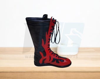 May include: Black leather wrestling boots with red flame accents and black laces. The boots have a thick sole.
