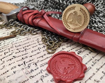 May include: A red leather-wrapped dagger with a brass seal featuring an eagle emblem, resting on aged parchment. A second red wax seal and chainmail are also visible. The dagger's blade is silver.