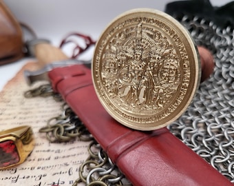 May include: A detailed gold-colored wax seal with an embossed design of a seated figure, resting on a red leather sheath. A gold ring with a red stone and a sword are also visible, along with chainmail and aged paper.