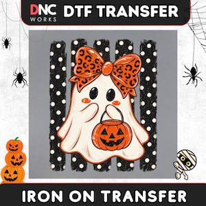 May include: A DTF transfer featuring a white ghost with a leopard print bow, holding an orange jack-o'-lantern bucket. The ghost is centered against a background of black vertical stripes with white polka dots. The text DNC WORKS DTF TRANSFER is visible.