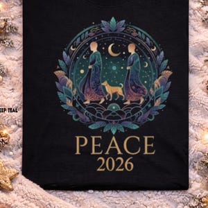 May include: Black t-shirt featuring a circular design with two figures in flowing robes, a dog, and a crescent moon. The design is surrounded by leaves and the text "PEACE 2026". The word "Black" is at the top.