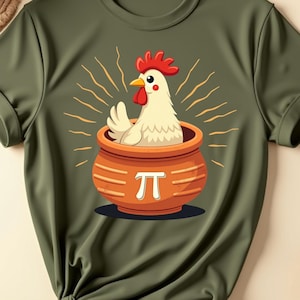 May include: Olive green t-shirt featuring a cartoon chicken in a pot with the pi symbol. The chicken has a red comb and beak. The pot is orange with a white pi symbol. The shirt has rolled-up sleeves.