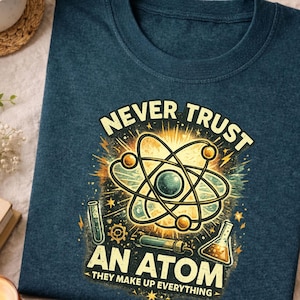 This science themed graphic shirt features a clever and humorous physics joke built around the classic atom concept. The design uses clean typography and a balanced layout to highlight the joke clearly, making it easy to read and instantly recognizable for science lovers. The artwork feels simple yet expressive, focusing on humor that connects with teachers, students, and anyone who enjoys clever science wordplay.

The visual style is intentionally minimal and classroom friendly, avoiding