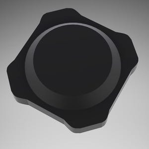 May include: A black, hexagonal-shaped, plastic lid with a raised, circular rim.