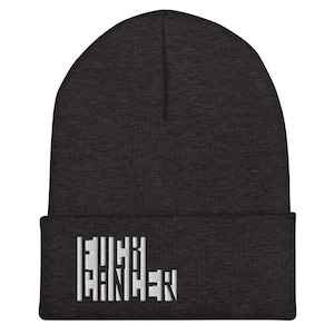 May include: Dark grey beanie hat with the white text "FUCK CANCER". The beanie is a knitted cap, ideal for colder weather. The text is centered on the front of the folded brim.