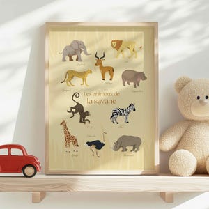 May include: A framed print featuring illustrations of savanna animals, including an elephant, lion, and zebra. The text "Les animaux de la savane" is displayed. A red toy car and a beige teddy bear sit on a wooden shelf.