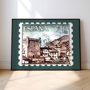 May include: A vintage Spanish postage stamp with a green border and a picture of a village with a castle in the mountains. The stamp says "ESPAÑA 40 CTS CORREOS".