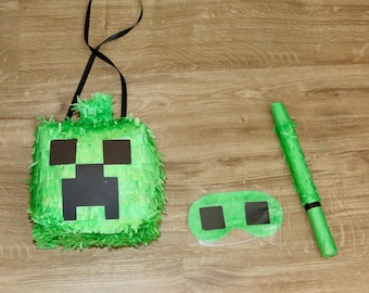 Minecraft inspired Creeper piñata with buster and blindfold. Minecraft theme party