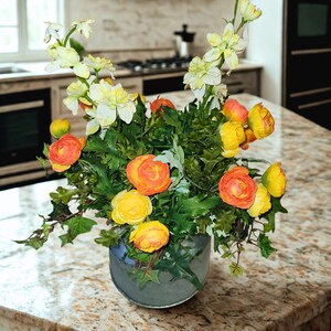 Orange and yellow flowers and a metal milk can with a pretty green sheer bow