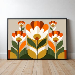 May include: A framed horizontal wall art print featuring a stylized floral pattern with five symmetrical flowers in shades of orange, white, brown, and mustard yellow, set against a light beige background with dark green and olive foliage.
