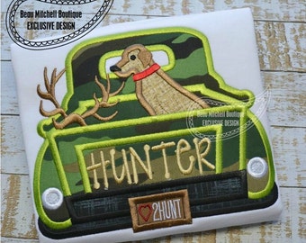 Hunting truck with deer antlers and hunting dog