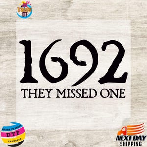 May include: A black heat transfer design featuring the large numbers 1692 in a stylized, jagged font. Below the numbers, the text reads "THEY MISSED ONE" in a matching black, distressed typeface. The design is presented on a light background.