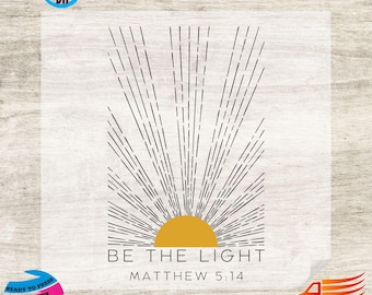 May include: A digital transfer design featuring a black and white sunburst with a yellow sun in the center. The text "BE THE LIGHT" and "MATTHEW 5:14" is below the sun.