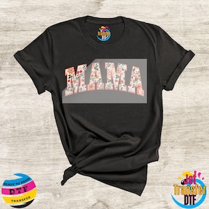 May include: Black t-shirt with a floral design that says "MAMA" in white letters.